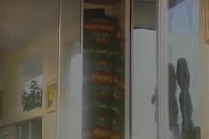 Marvelous redhead seductress of the 90's disrobes and bows over on the ottoman