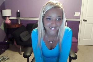 Sassy blond takes off her T-shirt and exposes large full natural bazookas