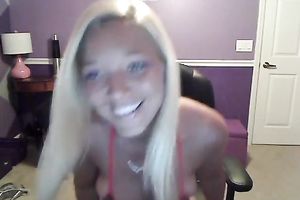Sassy blond takes off her T-shirt and exposes large full natural bazookas