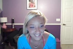 Sassy blond takes off her T-shirt and exposes large full natural bazookas