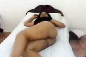 Lewd bootylicious Srilankan positions undressed on snow white ottoman