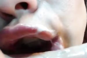 White whore on livecam blows a large dark fake penis and masturbates