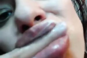 White whore on livecam blows a large dark fake penis and masturbates