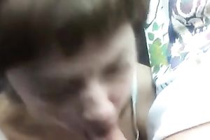 My short-haired aged woman gives me a head in the car