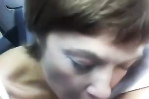 My short-haired aged woman gives me a head in the car