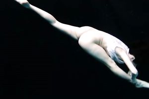 Skinny and tiny doxy underwater exposes her body