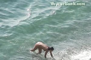 Sweet girlfriend and her guy were sunbathing nude on the beach