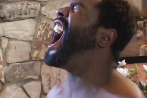 Tempted dark face is overspread with sticky white sperm