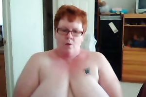 Short haired redhead aged web camera slut shows off her giant titties