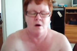 Short haired redhead aged web camera slut shows off her giant titties