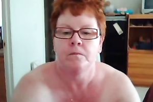 Short haired redhead aged web camera slut shows off her giant titties