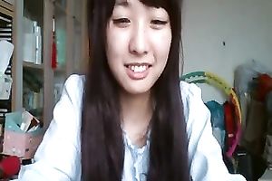 Long-haired Asian sweetheart flashes her pants for the web camera