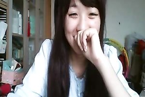Long-haired Asian sweetheart flashes her pants for the web camera