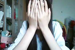 Long-haired Asian sweetheart flashes her pants for the web camera