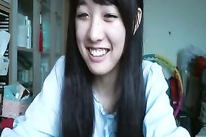 Long-haired Asian sweetheart flashes her pants for the web camera
