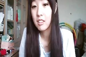 Long-haired Asian sweetheart flashes her pants for the web camera