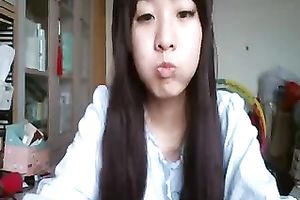 Long-haired Asian sweetheart flashes her pants for the web camera