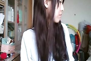 Long-haired Asian sweetheart flashes her pants for the web camera