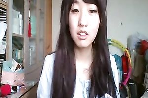 Long-haired Asian sweetheart flashes her pants for the web camera