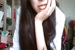 Long-haired Asian sweetheart flashes her pants for the web camera