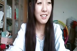 Long-haired Asian sweetheart flashes her pants for the web camera