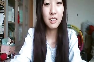 Long-haired Asian sweetheart flashes her pants for the web camera