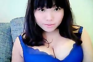 Cute dilettante dark brown Asian model girl on cam teases me with her tits