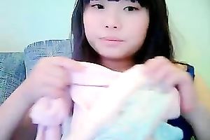 Cute dilettante dark brown Asian model girl on cam teases me with her tits