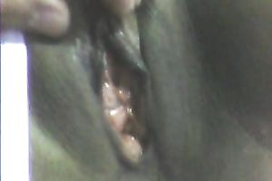 Stretching dark girl's anus with large sex toy