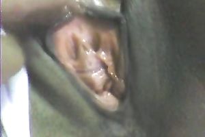 Stretching dark girl's anus with large sex toy