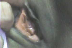 Stretching dark girl's anus with large sex toy