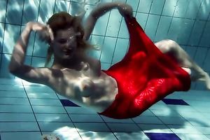 Blonde breasty European teenie in red costume underwater