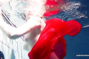 Blonde breasty European teenie in red costume underwater