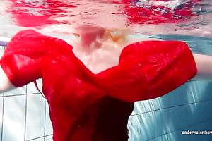 Blonde breasty European teenie in red costume underwater