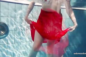 Blonde breasty European teenie in red costume underwater