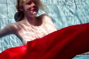 Blonde breasty European teenie in red costume underwater