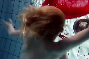 Blonde breasty European teenie in red costume underwater