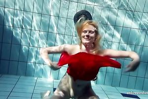Blonde breasty European teenie in red costume underwater