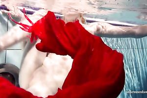 Blonde breasty European teenie in red costume underwater