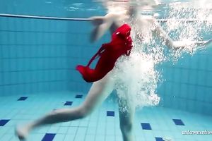 Blonde breasty European teenie in red costume underwater