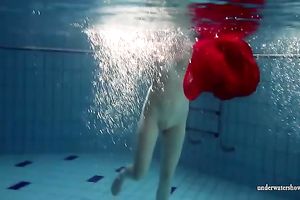 Blonde breasty European teenie in red costume underwater