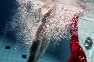 Blonde breasty European teenie in red costume underwater