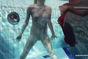 Blonde breasty European teenie in red costume underwater