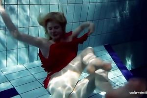 Blonde breasty European teenie in red costume underwater