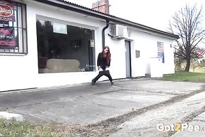 Sweet redhead playgirl pisses in front of a shop window