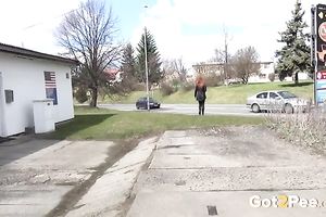 Sweet redhead playgirl pisses in front of a shop window