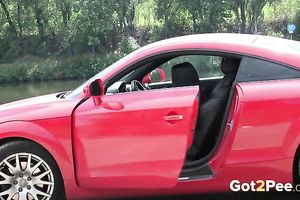 Exquisite elegant rich housewife in fancy red car pissing