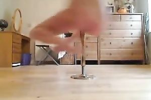 Flexible golden-haired doll with beautiful body is pole dancing on livecam