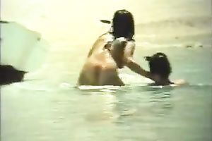 Sweet dark brown cutie rides her boyfriend on the beach