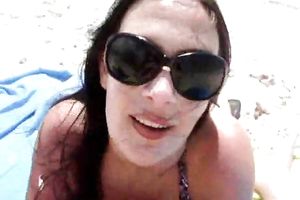 Slender brunette hair babe gives me a oral-stimulation at the beach